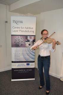 Performance from materials to music. Dr Sybille Fischer (EOS GmbH) playing the PEEK violin (one of the first four manufactured worldwide) at the High Performance Polymers Additive Manufacturing Event at the Centre for Additive Layer Manufacturing (CALM), University of Exeter. 